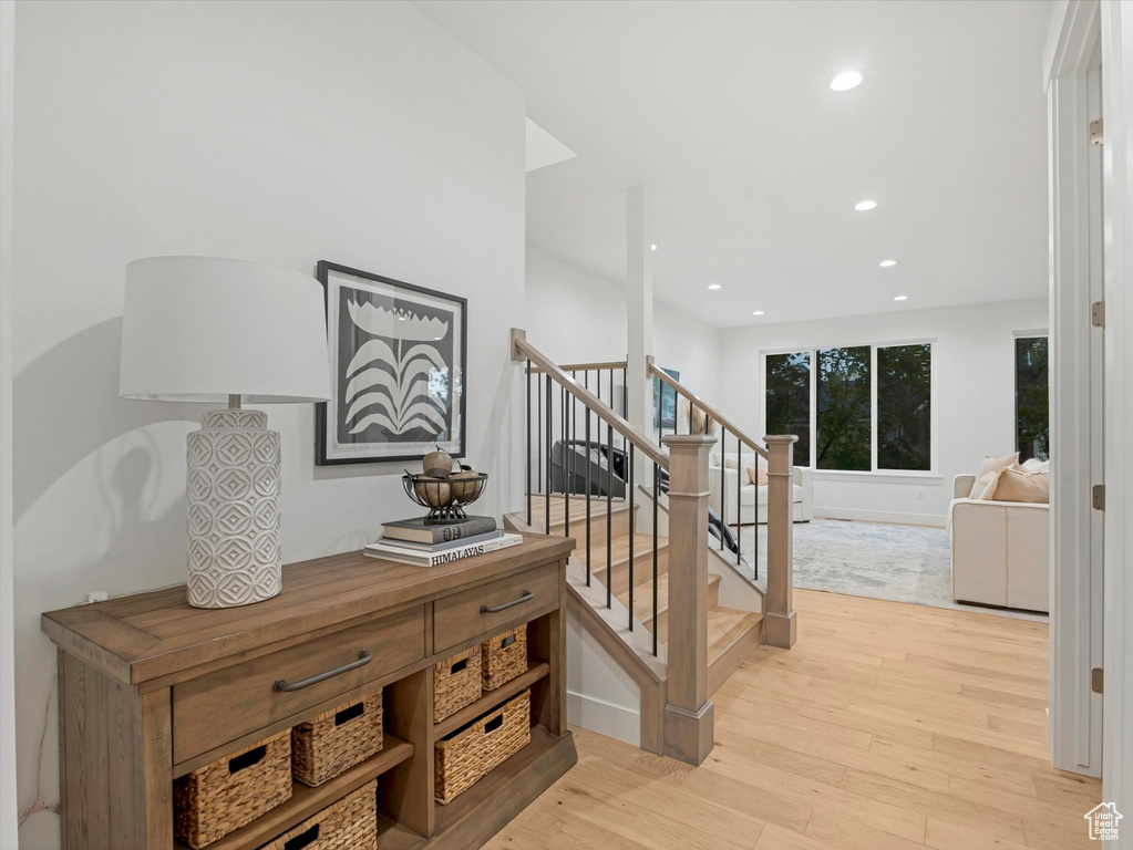 Staircase featuring recessed lighting and wood finished floors