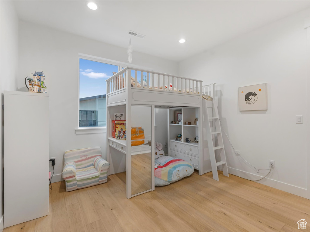 Bedroom with recessed lighting, visible vents, wood finished floors, and baseboards
