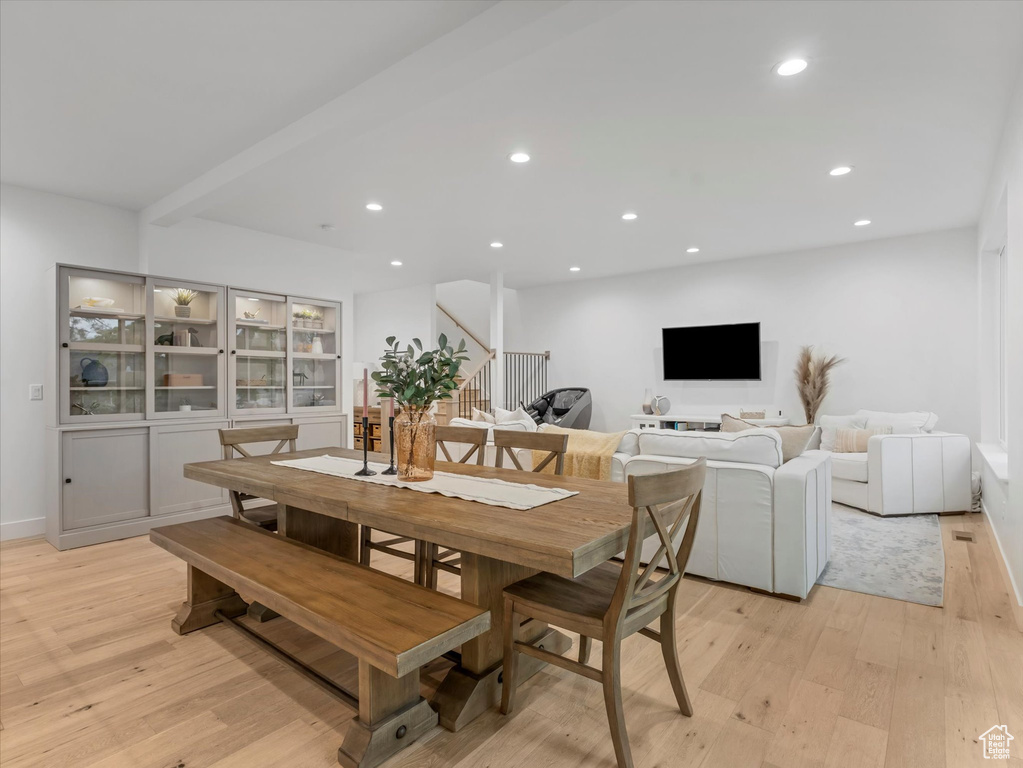 Dining room featuring light wood-type flooring, recessed lighting, baseboards, and stairs