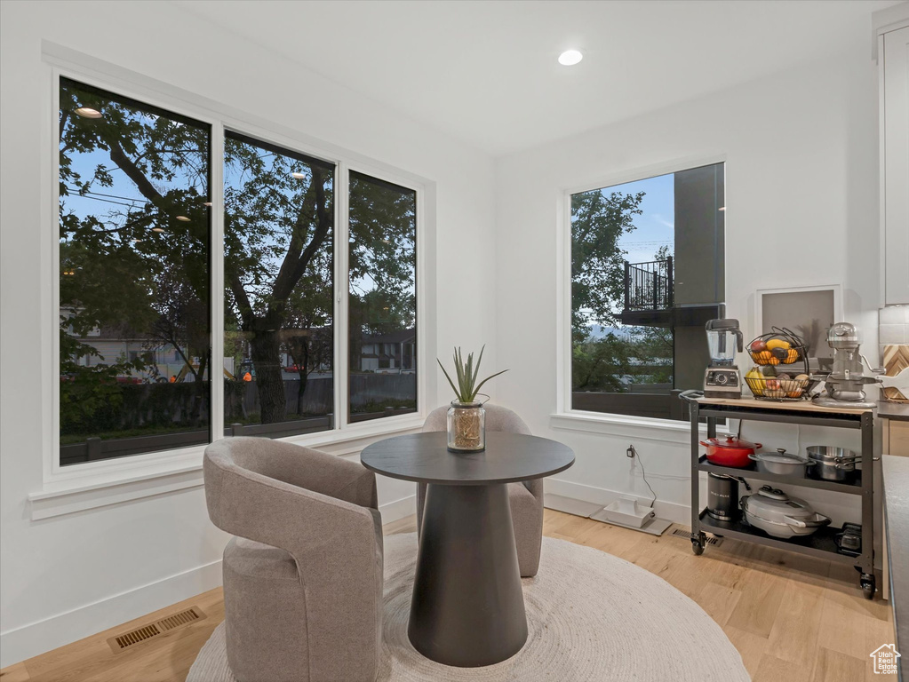 Dining space featuring baseboards, visible vents, and light wood-style flooring