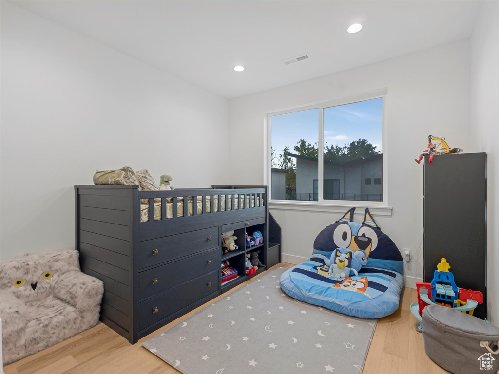 Bedroom with recessed lighting, visible vents, wood finished floors, and baseboards