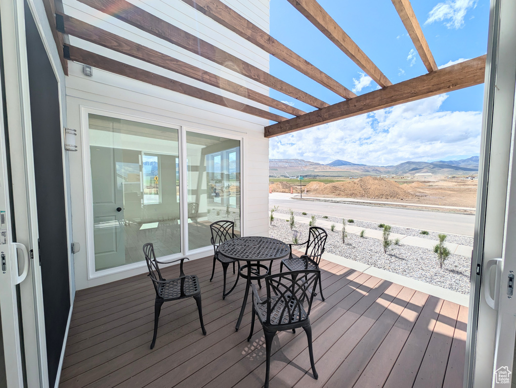Deck featuring a mountain view and a pergola