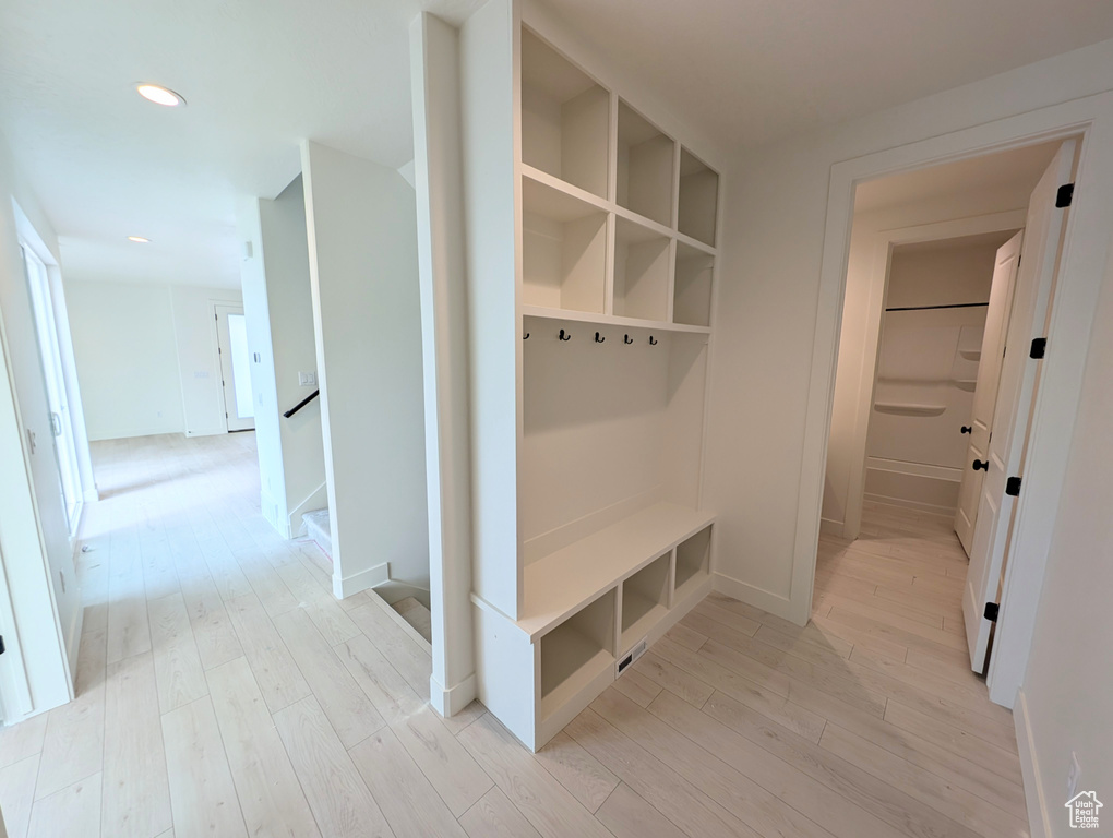 Mudroom with light wood finished floors and recessed lighting