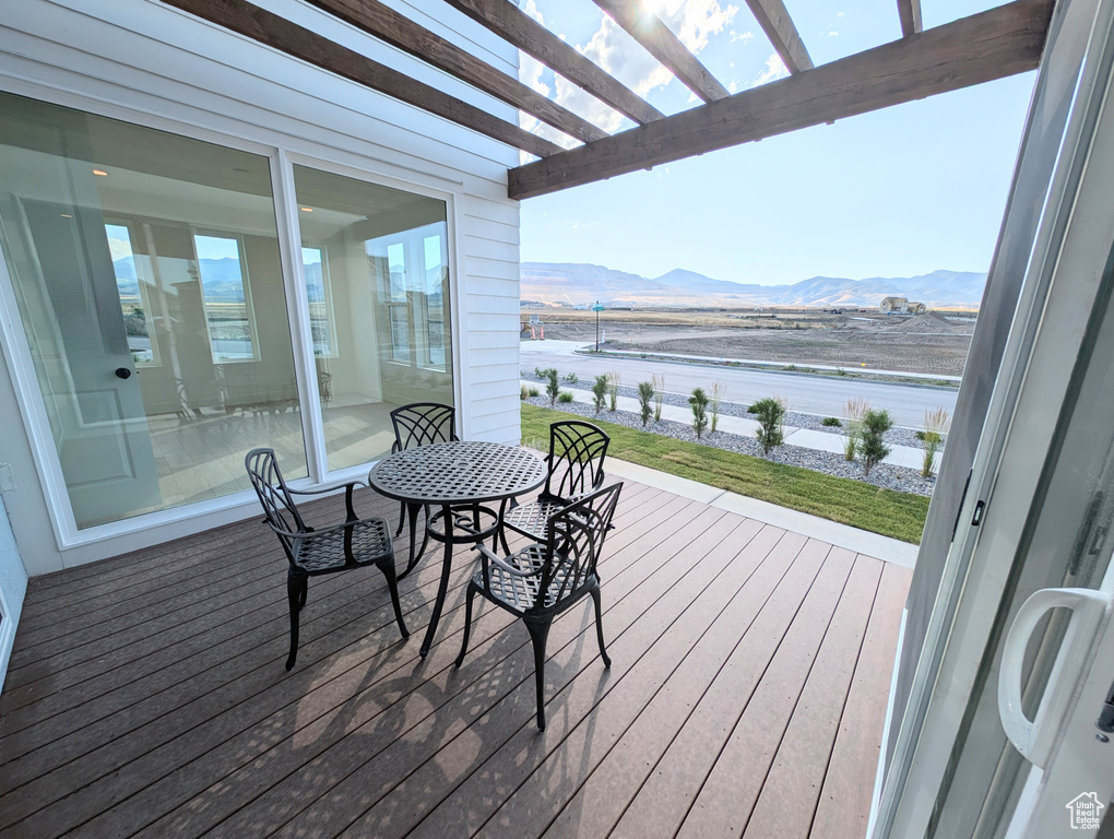 Balcony featuring a pergola and a deck with mountain view