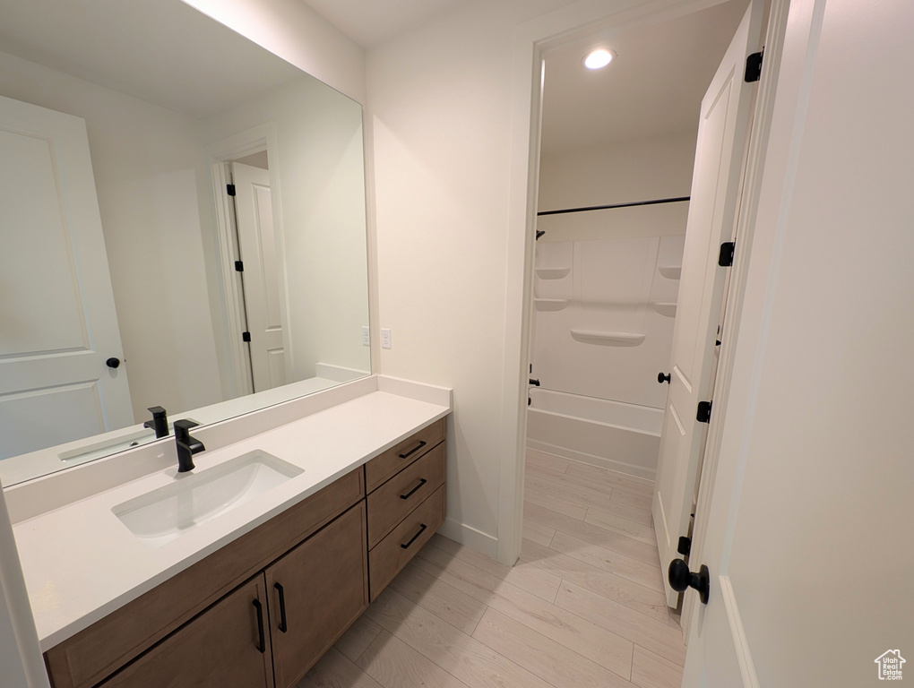 Full bath with shower / washtub combination, baseboards, vanity, and recessed lighting