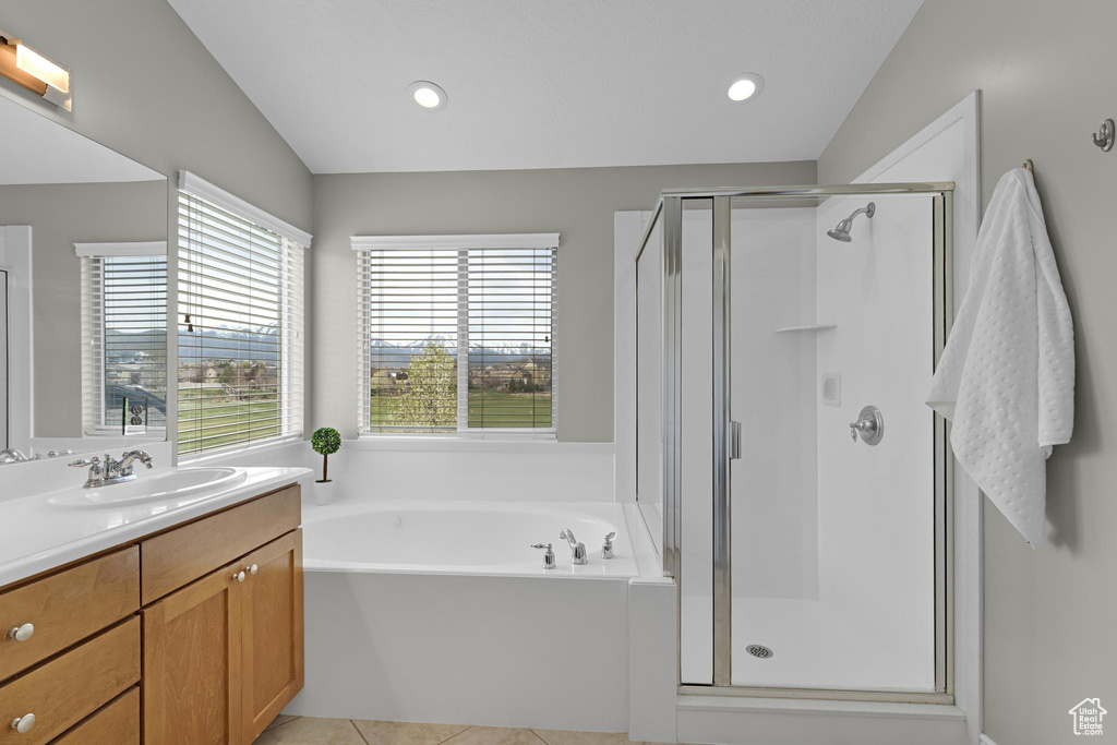 Bathroom featuring a garden tub, vanity, recessed lighting, and a shower stall