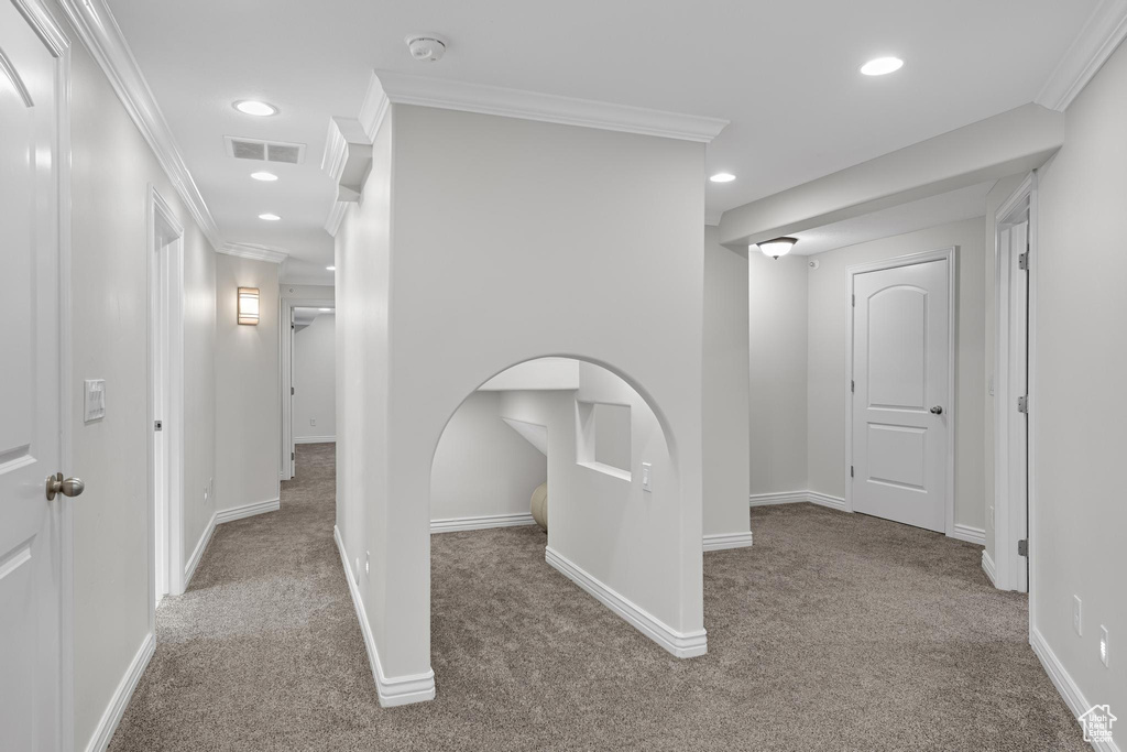 Hallway featuring ornamental molding, recessed lighting, visible vents, and carpet