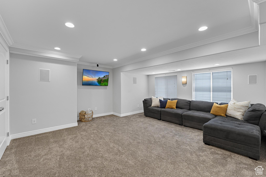 Carpeted living area with recessed lighting, ornamental molding, and baseboards