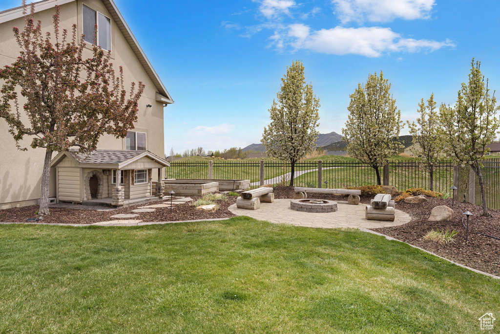 View of yard with a patio, an outdoor fire pit, and a fenced backyard