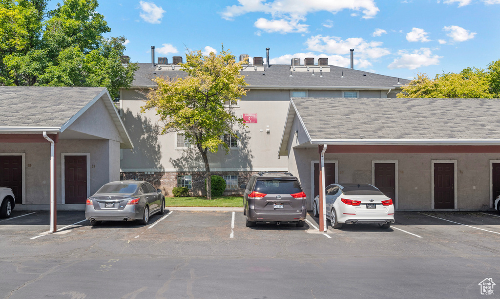 View of property featuring uncovered parking