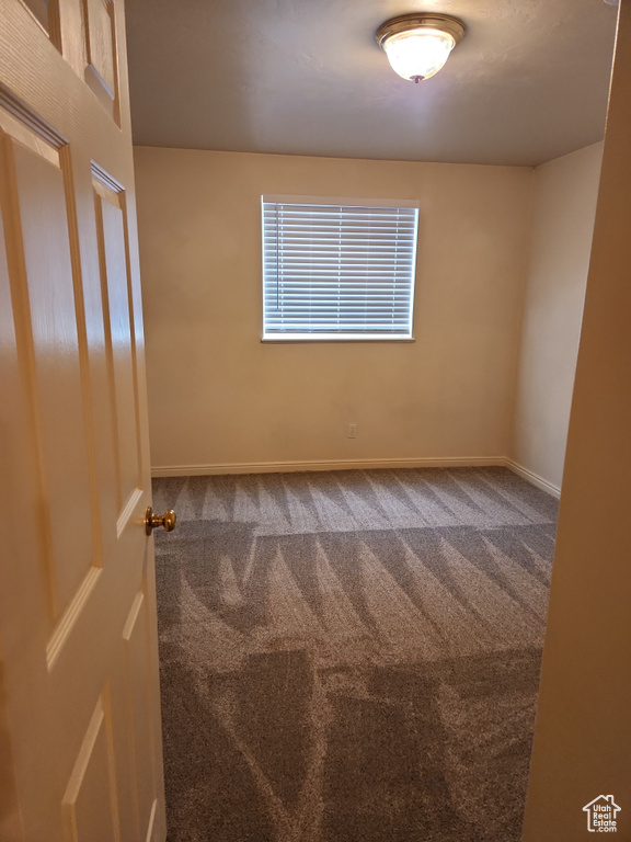 Carpeted empty room with baseboards