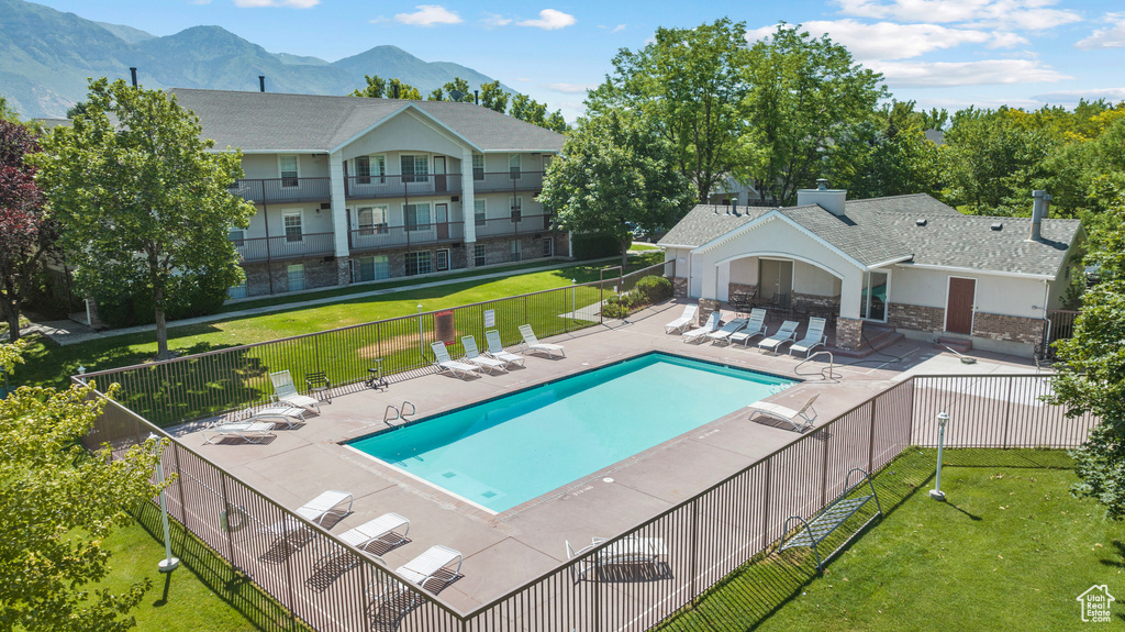Community pool with a patio and a mountain view