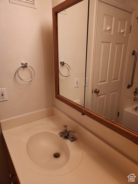Bathroom featuring bathing tub / shower combination and vanity
