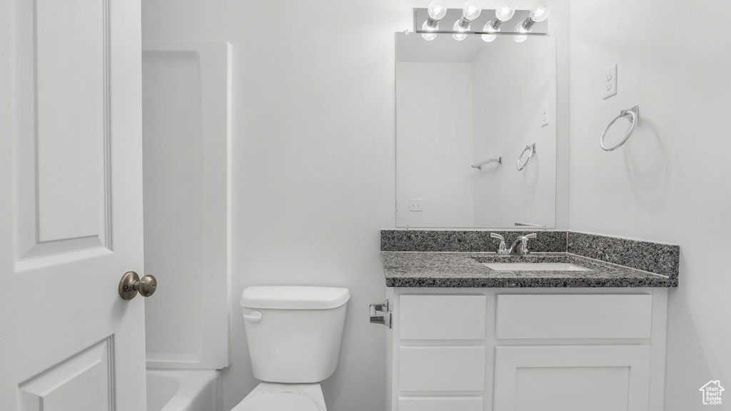 Full bathroom featuring toilet and vanity