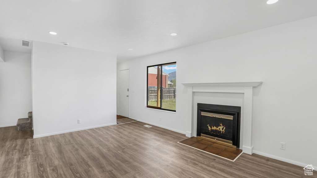 Unfurnished living room featuring wood finished floors, recessed lighting, and visible vents