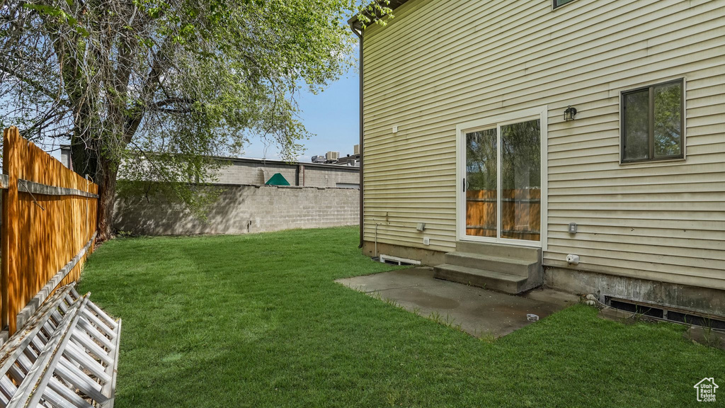 View of yard with entry steps and a fenced backyard