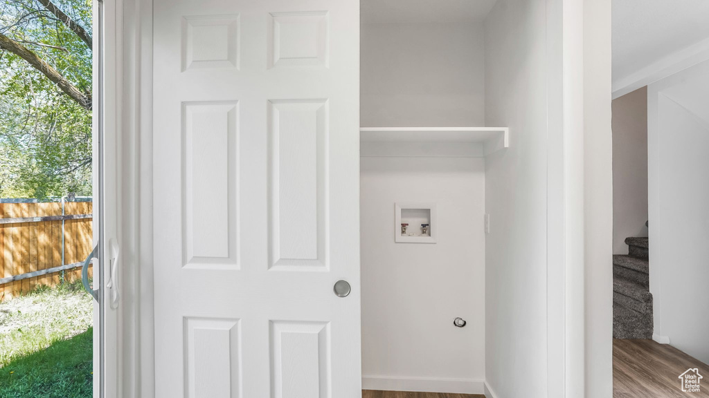 Laundry room featuring wood finished floors, washer hookup, and laundry area
