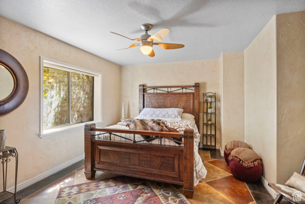 Bedroom with baseboards and a ceiling fan