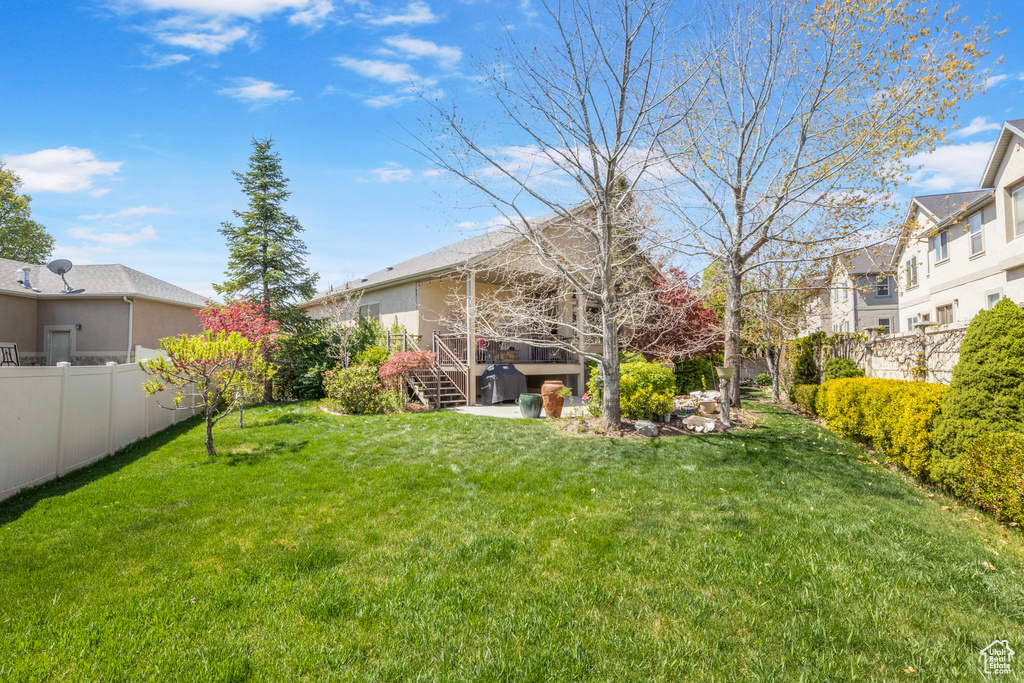 View of yard featuring fence, a residential view, and stairway