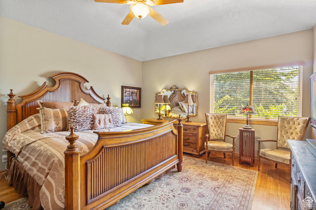 Bedroom featuring baseboards, a ceiling fan, and wood finished floors