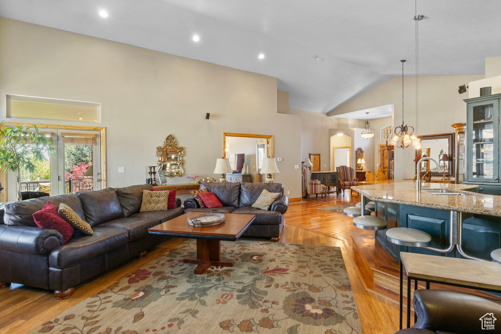 Living room featuring recessed lighting, parquet flooring, and high vaulted ceiling