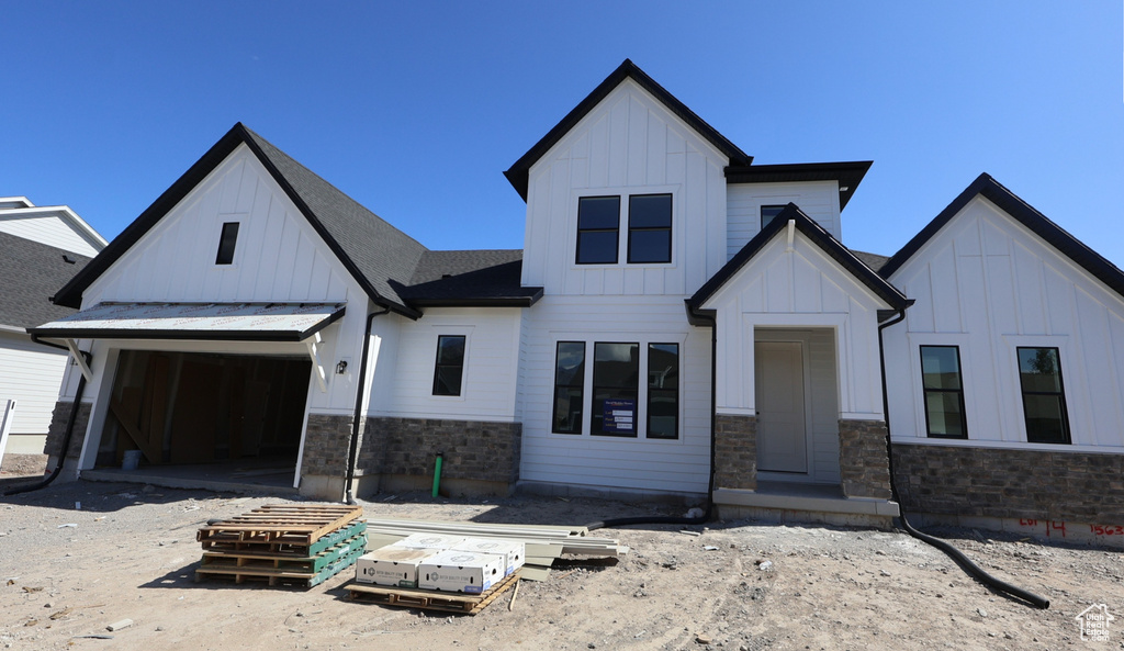 Modern farmhouse style home with board and batten siding and stone siding