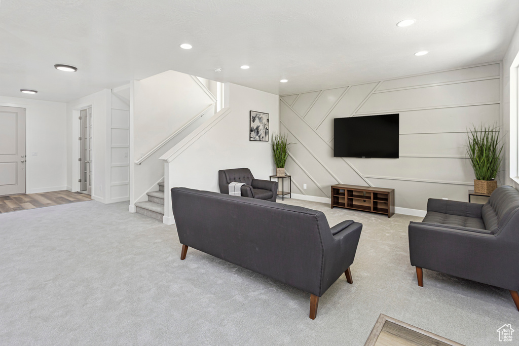 Living room featuring recessed lighting, stairs, and carpet