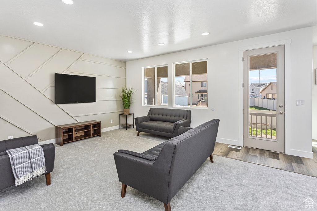 Living area featuring recessed lighting, carpet floors, and plenty of natural light