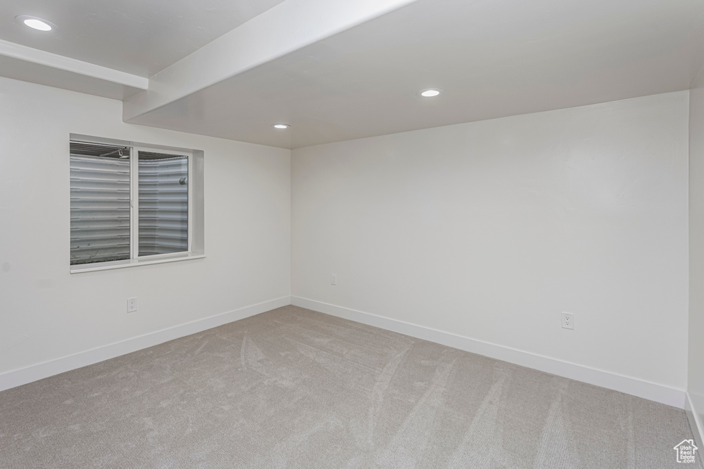 Carpeted spare room featuring recessed lighting and baseboards
