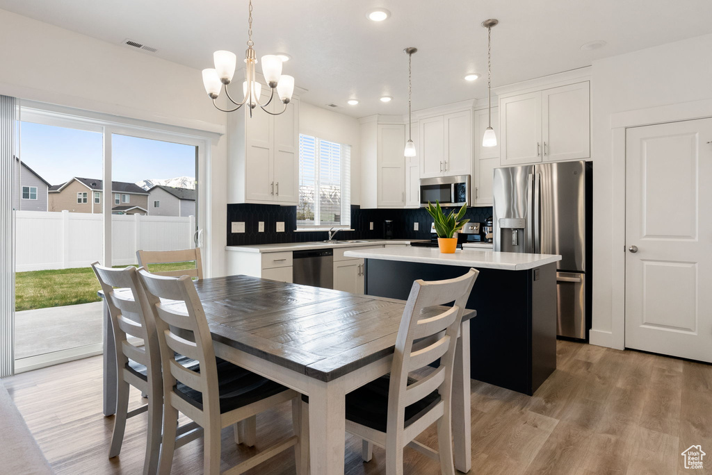 Dining area featuring recessed lighting, a chandelier, visible vents, and light wood-style flooring