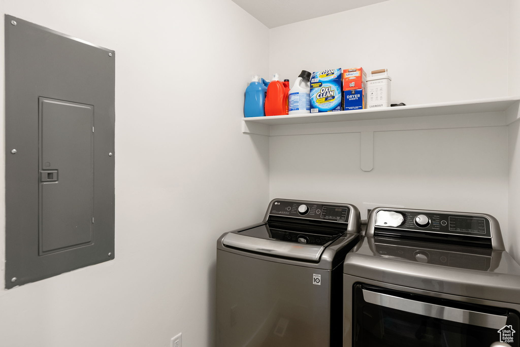 Laundry room with washing machine and dryer, electric panel, and laundry area