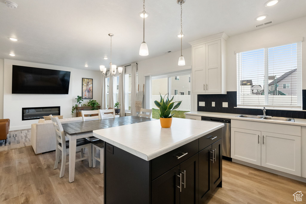 Kitchen featuring a sink, open floor plan, visible vents, an inviting chandelier, and dishwasher