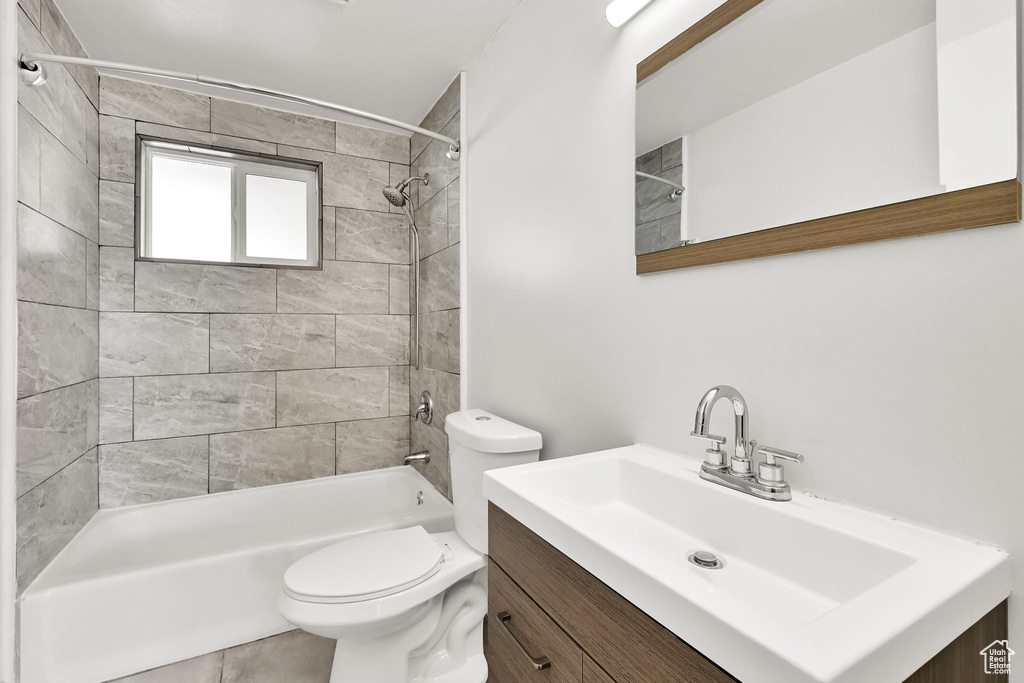 Full bathroom featuring vanity, toilet, and tub / shower combination