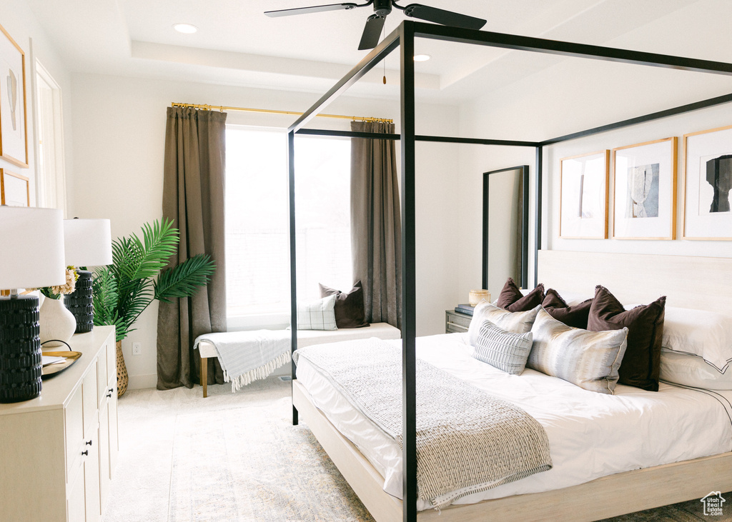 Bedroom featuring recessed lighting, a raised ceiling, a ceiling fan, and light carpet