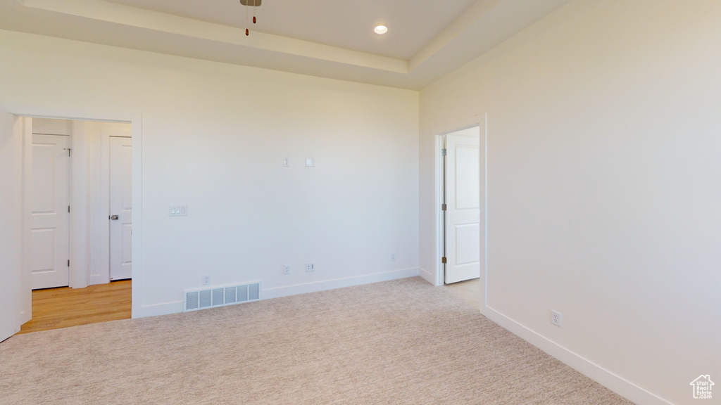 Unfurnished room with baseboards, visible vents, recessed lighting, light colored carpet, and a ceiling fan