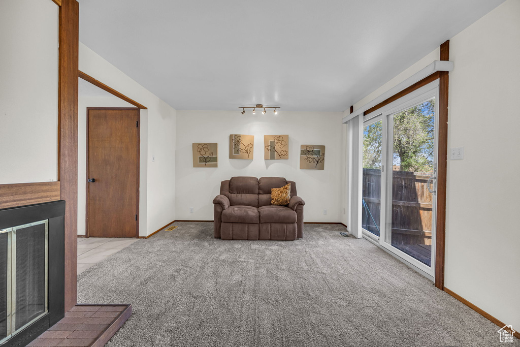 Living area with baseboards and carpet floors