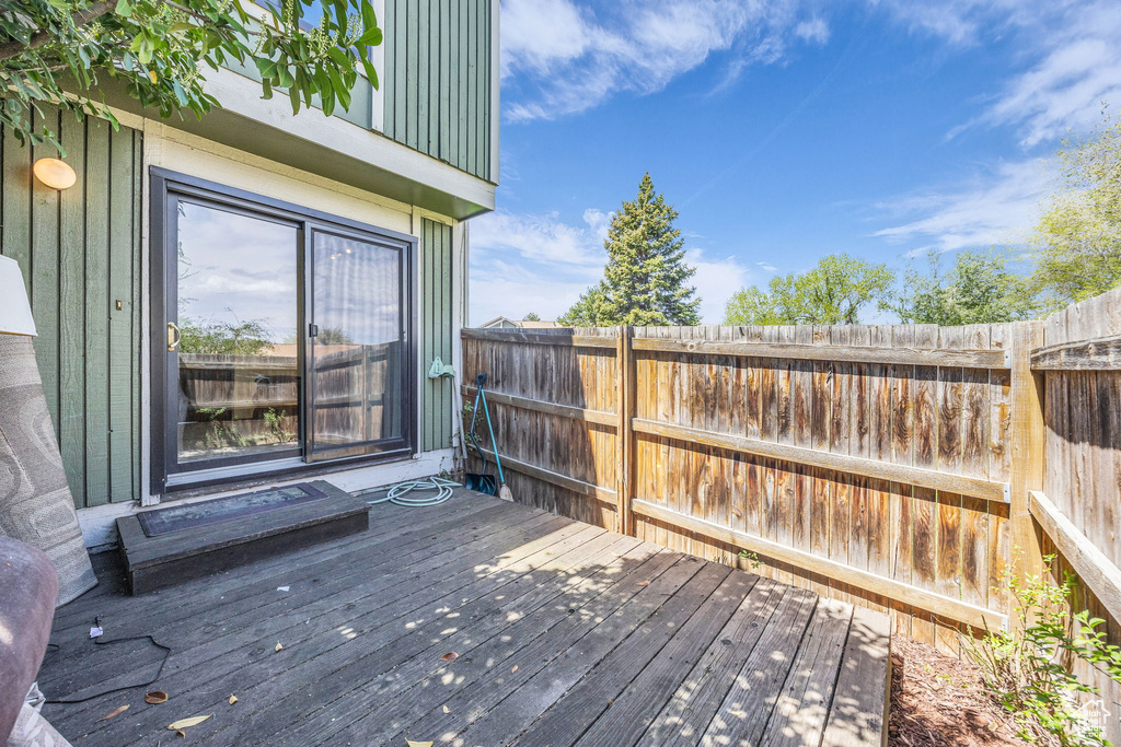 Wooden terrace featuring fence
