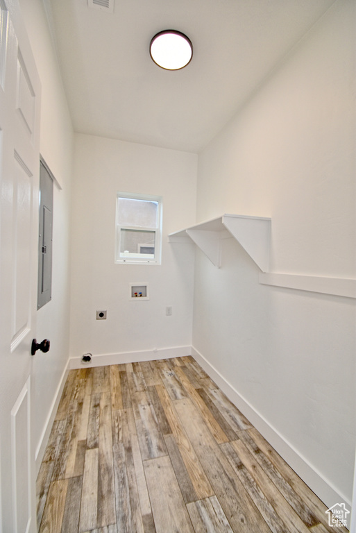 Washroom featuring hookup for an electric dryer, light wood-style flooring, visible vents, hookup for a washing machine, and laundry area