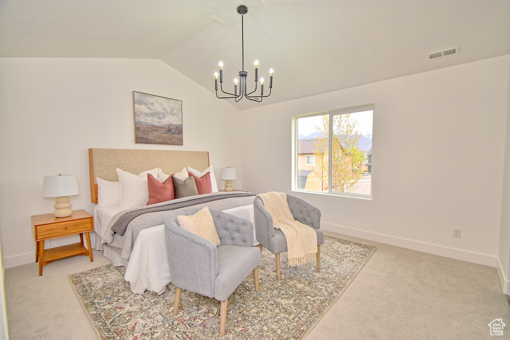 Bedroom with light colored carpet, baseboards, visible vents, a notable chandelier, and lofted ceiling