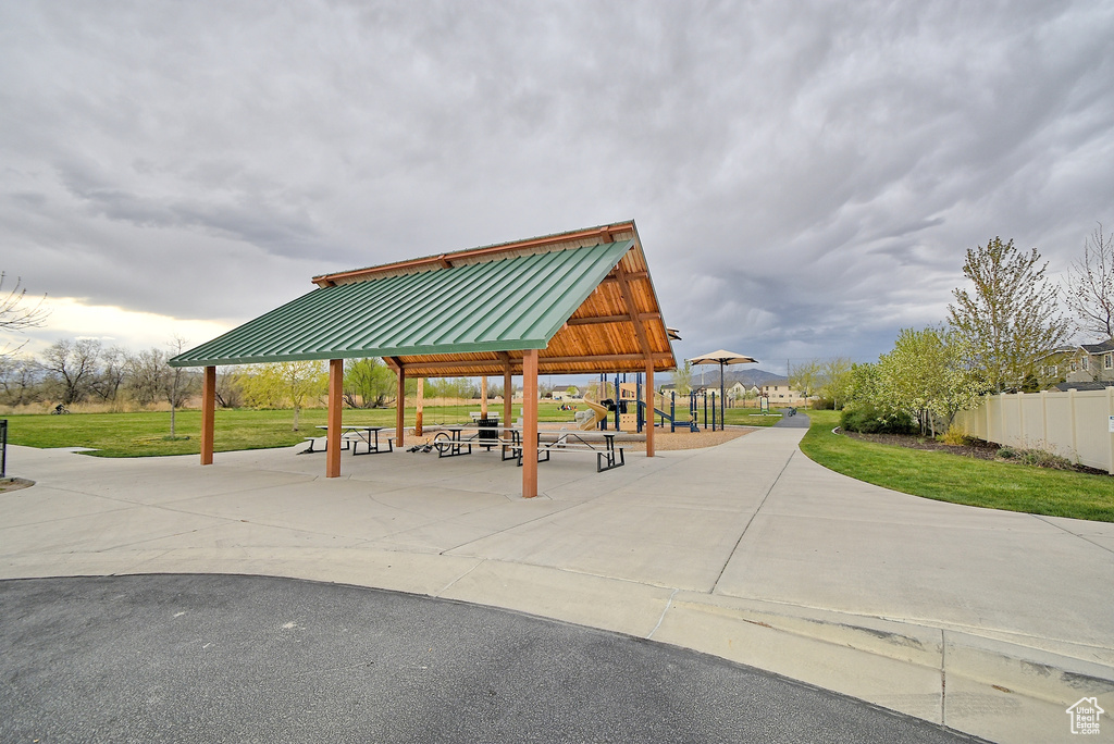 View of home\'s community featuring a lawn, a gazebo, and fence