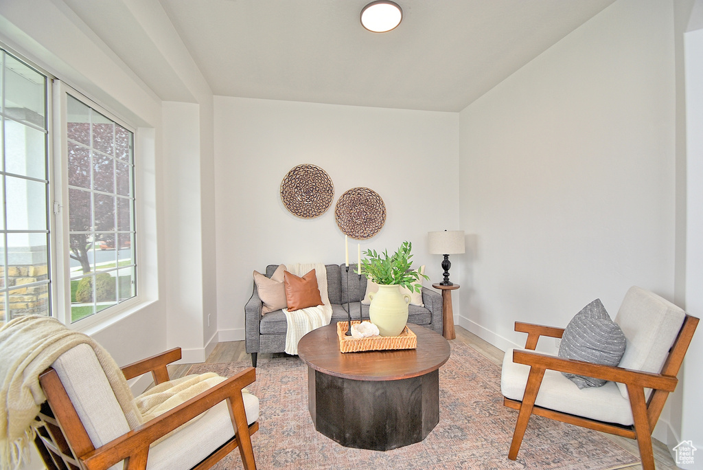 Living area with baseboards and wood finished floors