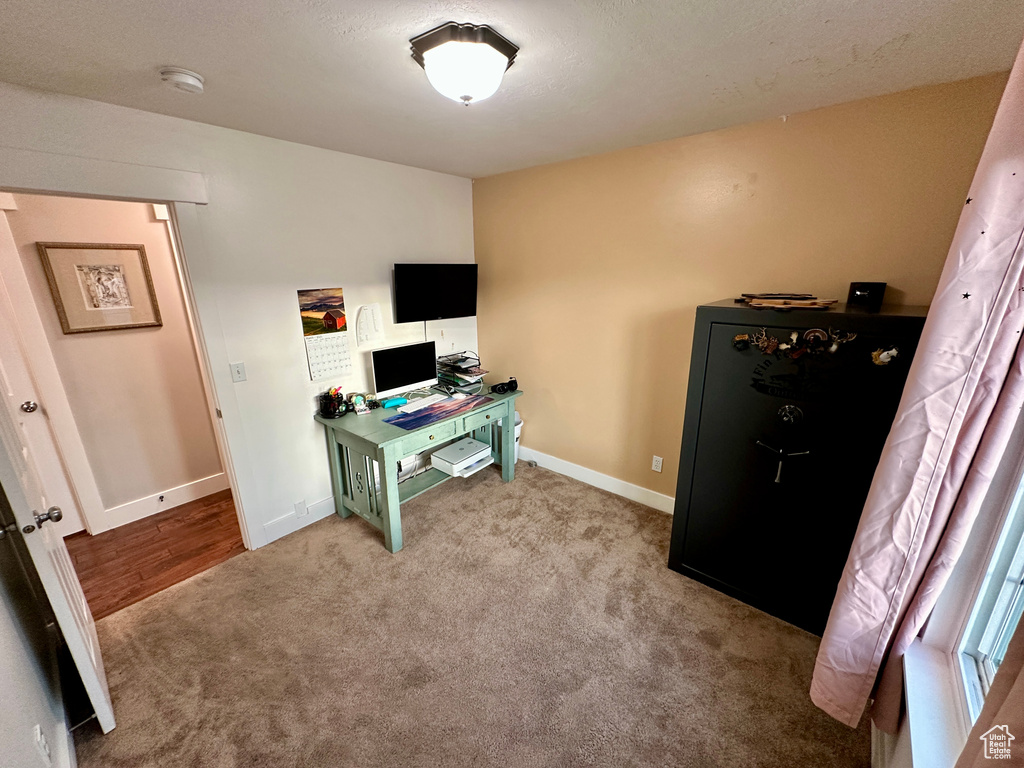 Home office featuring baseboards and carpet floors