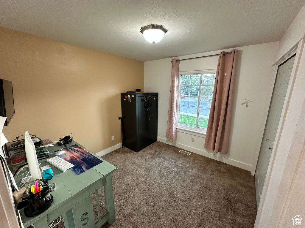 Office space with baseboards, visible vents, and carpet floors