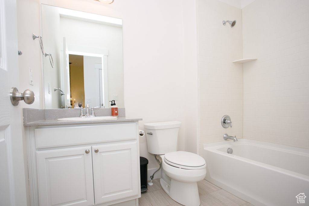 Full bath featuring vanity, toilet, shower / washtub combination, and tile patterned floors