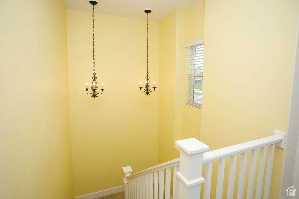 Staircase with a notable chandelier