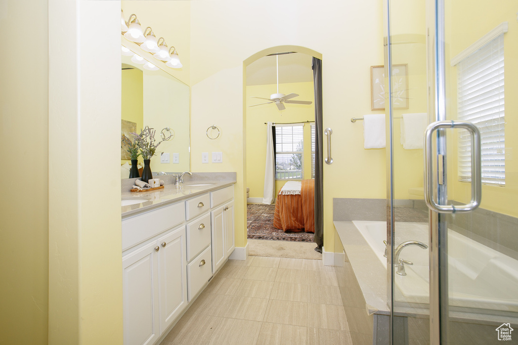 Ensuite bathroom featuring a shower with door, double vanity, a sink, a bath, and ensuite bath