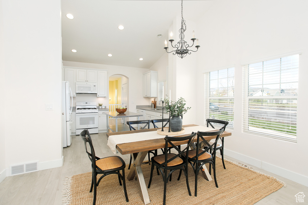 Dining room featuring baseboards, visible vents, arched walkways, and recessed lighting