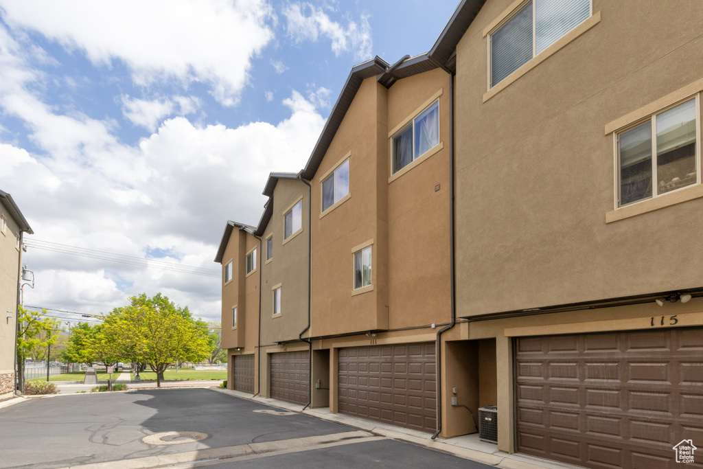 View of home\\\'s exterior with central air condition unit, a garage, and stucco siding