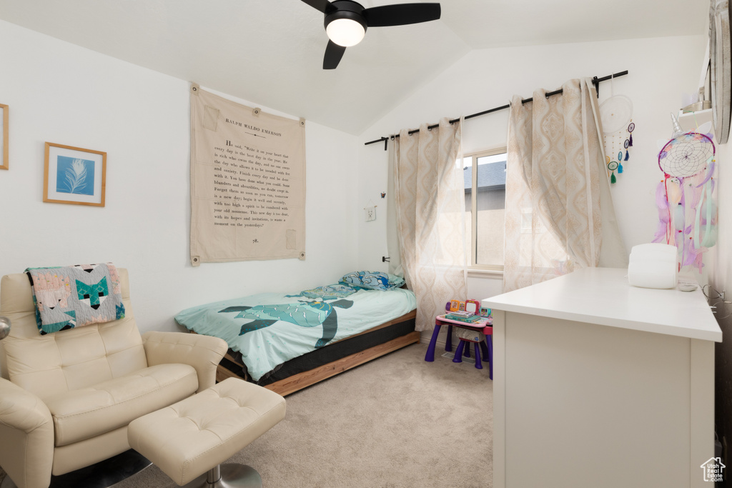 Bedroom featuring ceiling fan, vaulted ceiling, and carpet flooring