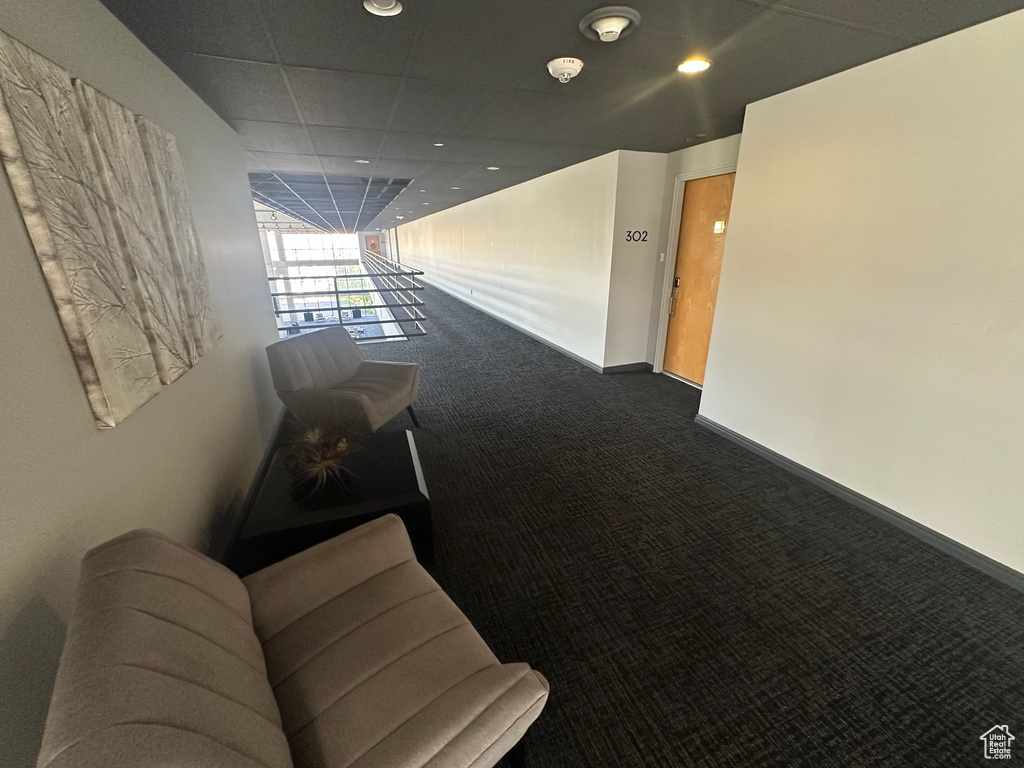 Hallway featuring baseboards, carpet, and recessed lighting